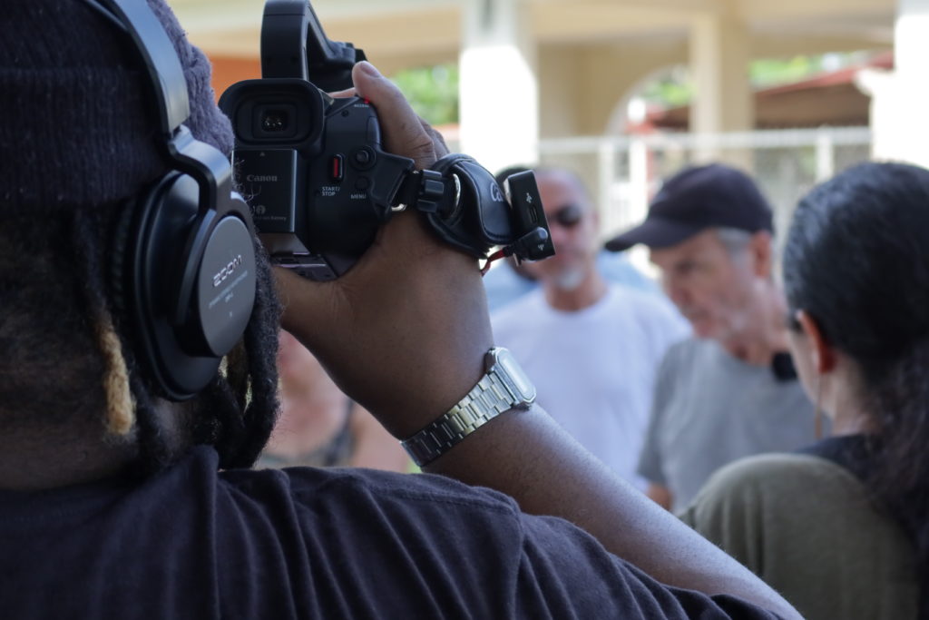Man using a camcorder to record for the Loiza Vive Project