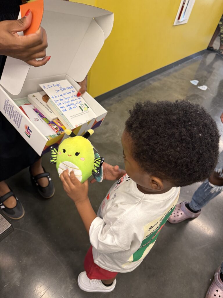 A young learner opens his LIFT kit at Early Childhood Academy Public Charter School.